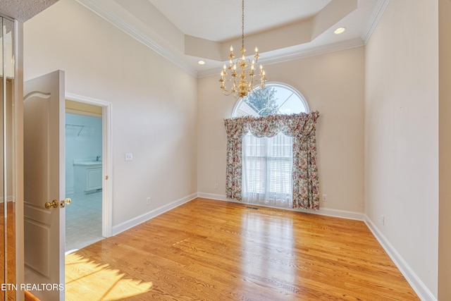 2150 Hirst Cir, Lenoir City, TN 37771 - empty room featuring a chandelier, light wood-style floors, a raised ceiling, crown molding, and recessed lighting