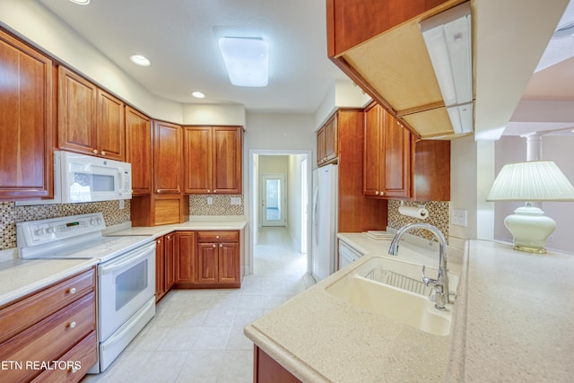2150 Hirst Cir, Lenoir City, TN 37771 - kitchen featuring white appliances, decorative backsplash, light countertops, recessed lighting, and brown cabinets