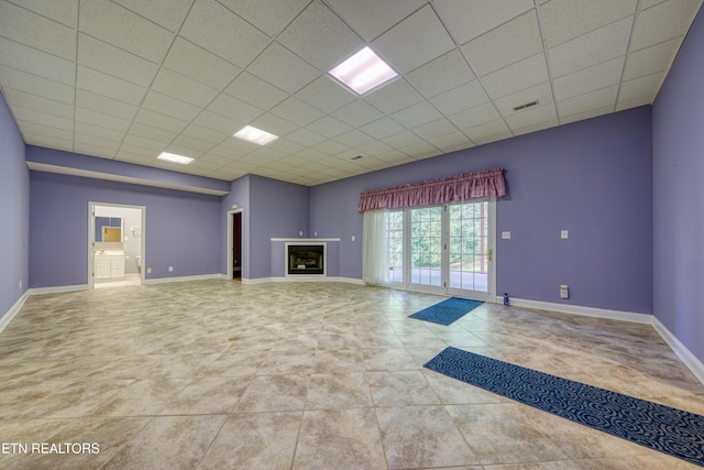 2150 Hirst Cir, Lenoir City, TN 37771 - unfurnished living room featuring a paneled ceiling, a fireplace, and tile patterned floors
