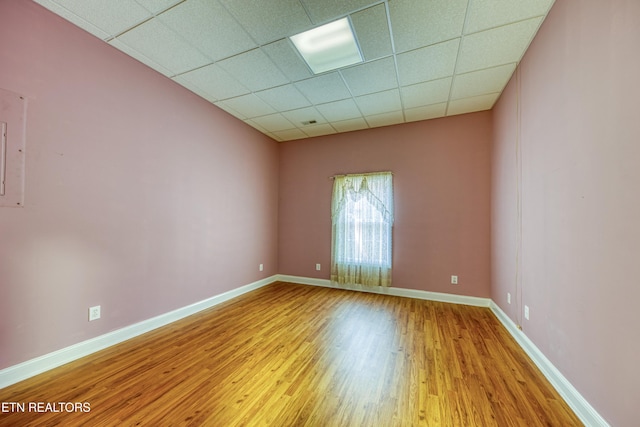 2150 Hirst Cir, Lenoir City, TN 37771 - empty room featuring wood finished floors and a drop ceiling