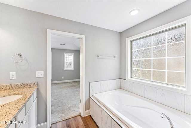 8630 Yellow Aster Rd, Knoxville, TN 37931 - bathroom featuring wood finished floors, a bath, and vanity