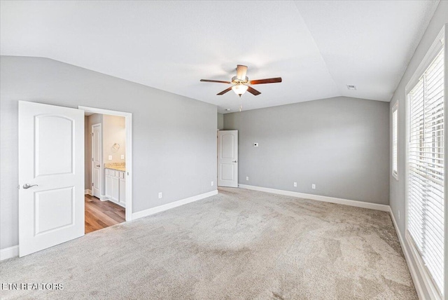 8630 Yellow Aster Rd, Knoxville, TN 37931 - unfurnished bedroom featuring vaulted ceiling, light colored carpet, multiple windows, ensuite bath, and ceiling fan