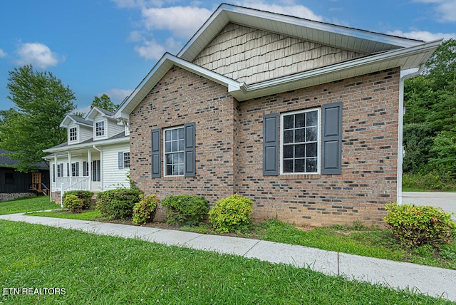200 W Park Cir, Decatur, TN 37322 - view of side of home with a yard, brick siding, and a porch