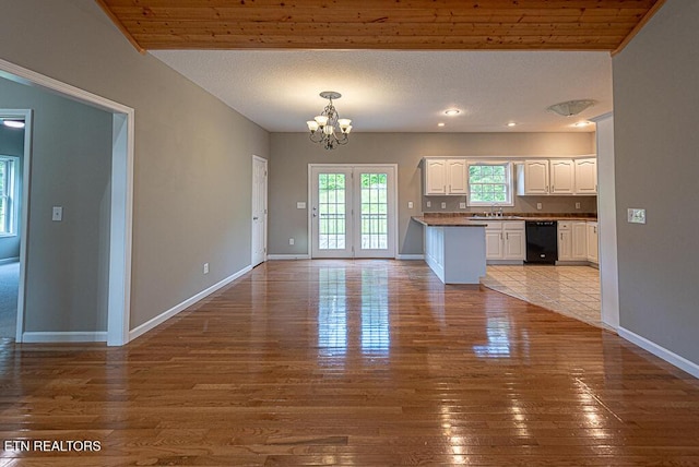 200 W Park Cir, Decatur, TN 37322 - kitchen with black dishwasher, white cabinets, a chandelier, hardwood / wood-style flooring, and open floor plan