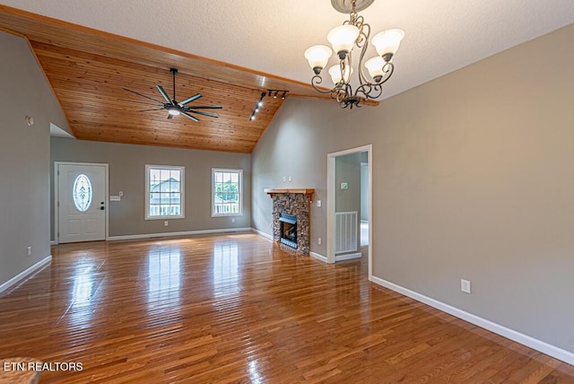200 W Park Cir, Decatur, TN 37322 - unfurnished living room featuring a chandelier, wood finished floors, a stone fireplace, ceiling fan, and high vaulted ceiling