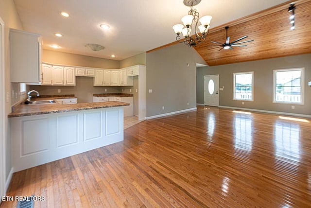 200 W Park Cir, Decatur, TN 37322 - kitchen featuring a peninsula, lofted ceiling, light wood-type flooring, a ceiling fan, and a chandelier