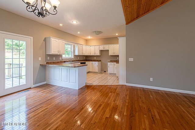 200 W Park Cir, Decatur, TN 37322 - kitchen with a peninsula, a chandelier, light wood-style floors, white cabinetry, and recessed lighting