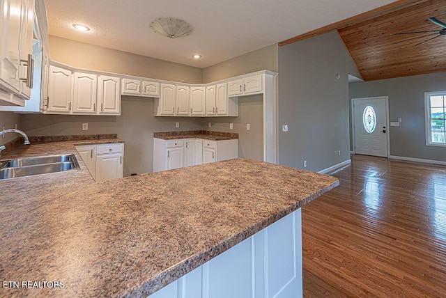 200 W Park Cir, Decatur, TN 37322 - kitchen featuring a peninsula, white cabinets, dark wood finished floors, lofted ceiling, and recessed lighting