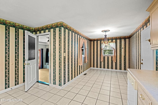 132 County Road 79, Riceville, TN 37370 - unfurnished dining area featuring wallpapered walls, light tile patterned floors, a textured ceiling, and a chandelier