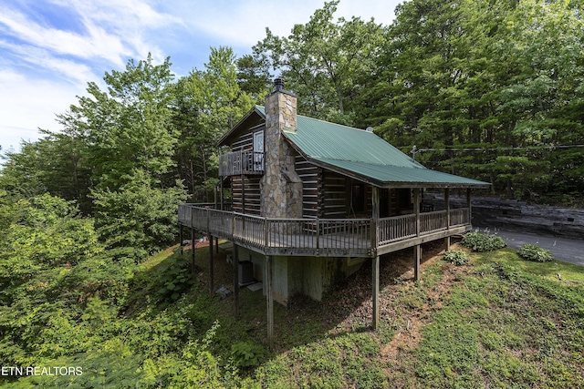 2526 N School House Gap Rd, Sevierville, TN 37876 - rear view of property featuring a wooden deck, a chimney, and a metal roof