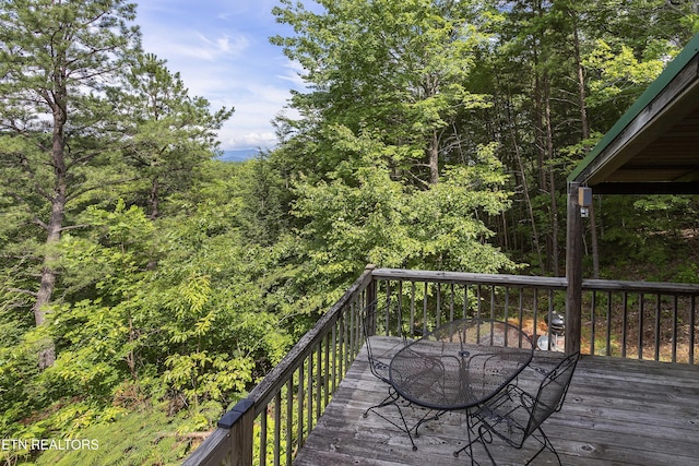 2526 N School House Gap Rd, Sevierville, TN 37876 - wooden terrace featuring outdoor dining area and a forest view