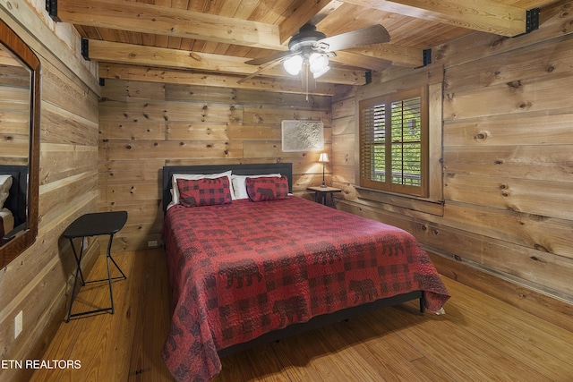 2526 N School House Gap Rd, Sevierville, TN 37876 - bedroom with a wooden ceiling with exposed beams, wood walls, wood-type flooring, and a ceiling fan