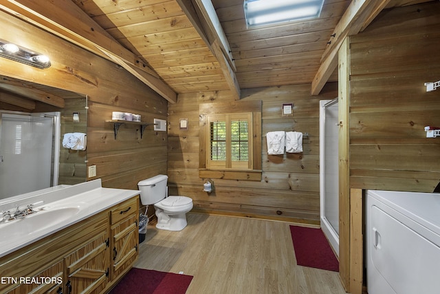 2526 N School House Gap Rd, Sevierville, TN 37876 - full bathroom featuring washer / clothes dryer, vanity, a stall shower, wood finished floors, and wood walls