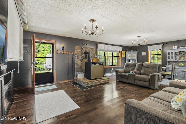4720 Laws Rd, Del Rio, TN 37727 - living room featuring a chandelier, a wood stove, wood finished floors, and wooden walls
