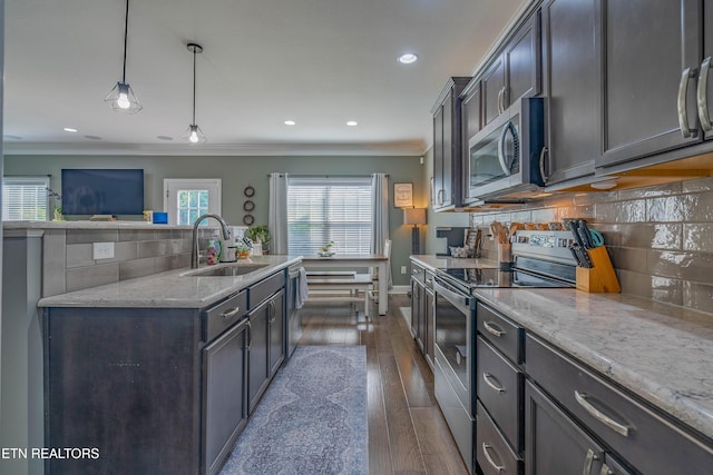 1221 Sky Top Ln, Powell, TN 37849 - kitchen with appliances with stainless steel finishes, ornamental molding, backsplash, light stone counters, and recessed lighting