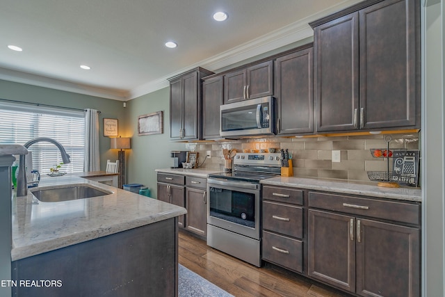 1221 Sky Top Ln, Powell, TN 37849 - kitchen with stainless steel appliances, crown molding, dark brown cabinetry, decorative backsplash, and dark wood-style flooring