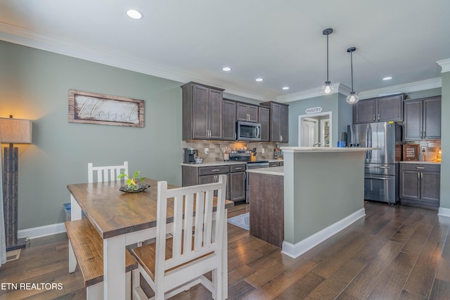 1221 Sky Top Ln, Powell, TN 37849 - kitchen featuring appliances with stainless steel finishes, decorative backsplash, ornamental molding, light countertops, and dark brown cabinets