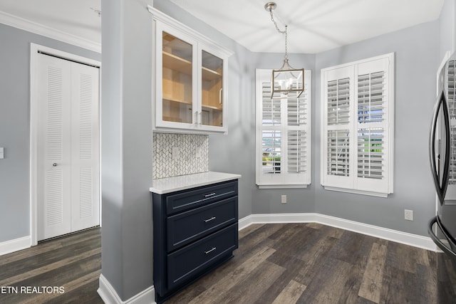 545 Rarity Bay Pkwy Unit 103, Vonore, TN 37885 - unfurnished dining area featuring dark wood-style floors, a chandelier, and crown molding