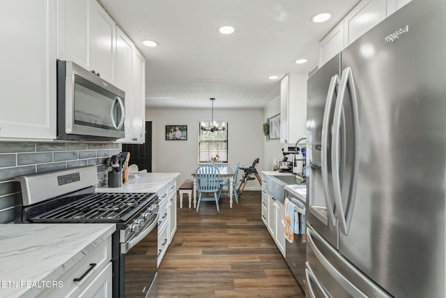 124 Pheasant Rd, Clinton, TN 37716 - kitchen with appliances with stainless steel finishes, dark wood finished floors, white cabinets, recessed lighting, and a chandelier