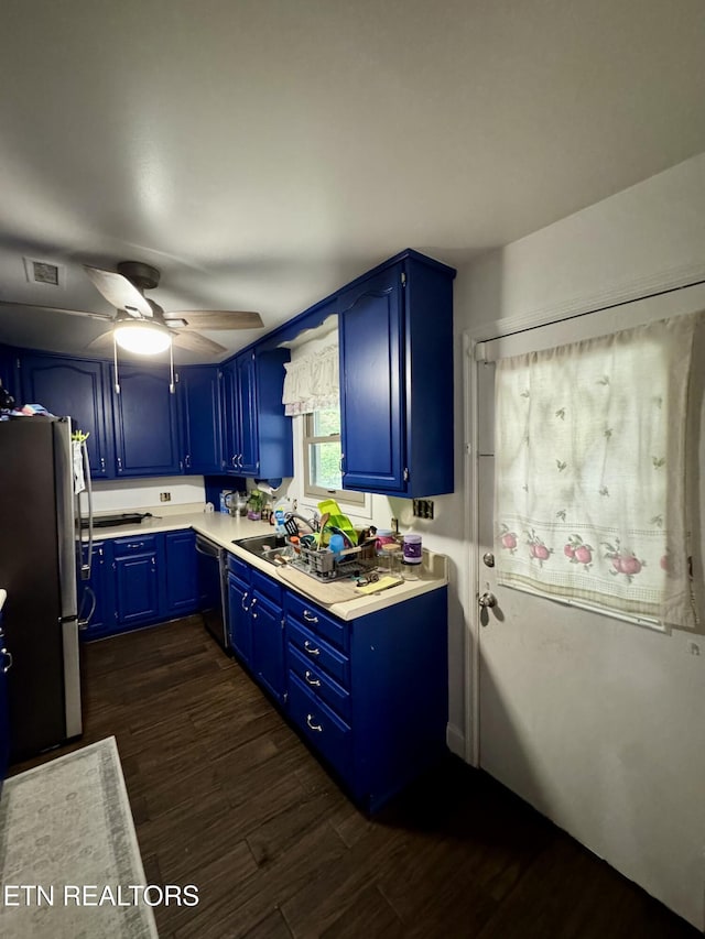 103 Albany Rd, Oak Ridge, TN 37830 - kitchen with freestanding refrigerator, blue cabinets, black dishwasher, light countertops, and dark wood-style floors
