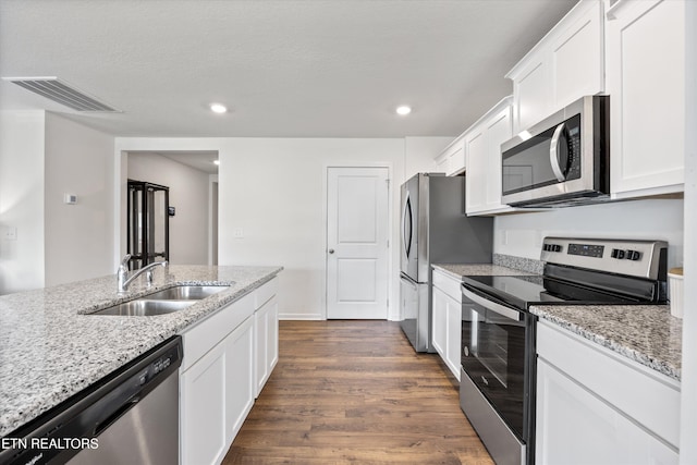 213 Newman Cir, Jefferson City, TN 37760 - kitchen featuring appliances with stainless steel finishes, dark wood-type flooring, white cabinets, light stone countertops, and recessed lighting