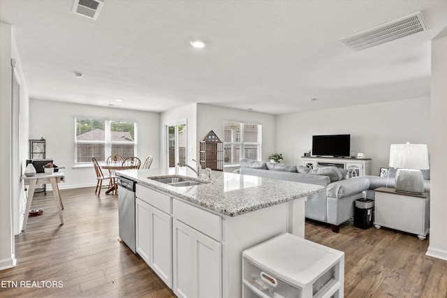213 Newman Cir, Jefferson City, TN 37760 - kitchen featuring dishwasher, light stone counters, dark wood finished floors, a center island with sink, and white cabinetry