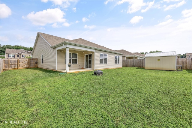 213 Newman Cir, Jefferson City, TN 37760 - rear view of property with a patio, a fenced backyard, a storage unit, and a shingled roof