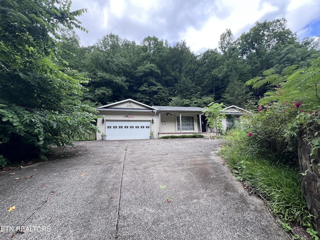 435 Simms Fork Rd, Arjay, KY 40902 - view of front of home featuring a garage, concrete driveway, and a porch