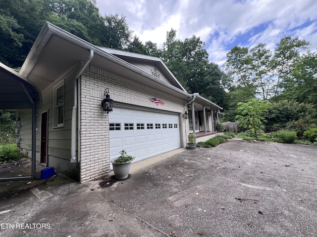 435 Simms Fork Rd, Arjay, KY 40902 - view of home's exterior with driveway, brick siding, and a garage