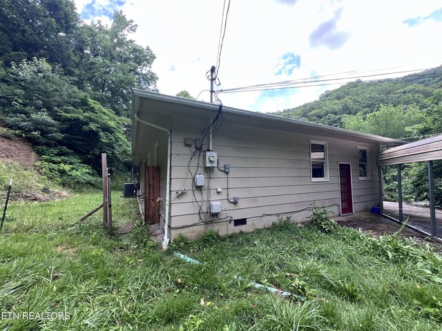 435 Simms Fork Rd, Arjay, KY 40902 - view of home's exterior with crawl space and a carport