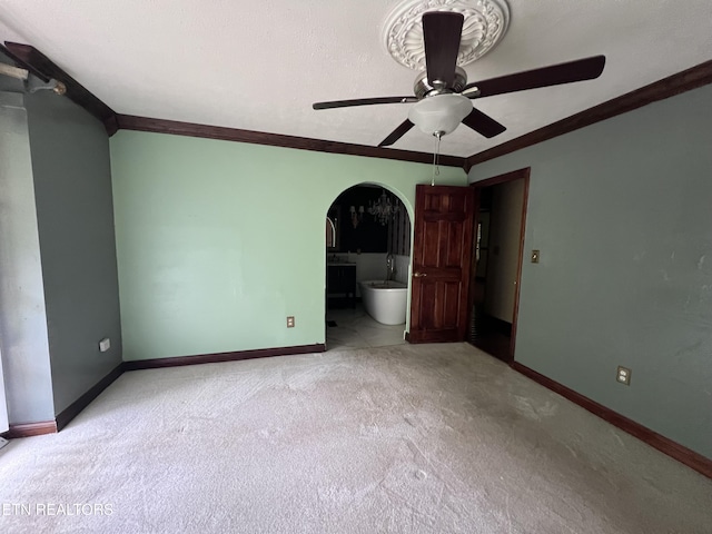 435 Simms Fork Rd, Arjay, KY 40902 - unfurnished bedroom featuring light carpet, arched walkways, ornamental molding, a ceiling fan, and connected bathroom