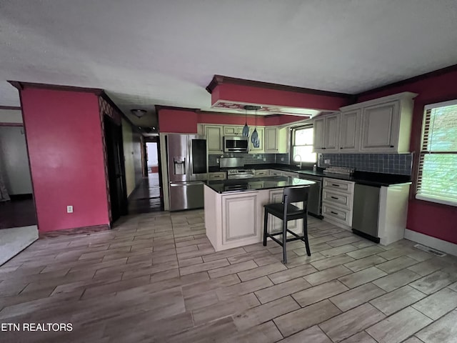 435 Simms Fork Rd, Arjay, KY 40902 - kitchen featuring appliances with stainless steel finishes, decorative backsplash, dark countertops, and healthy amount of natural light