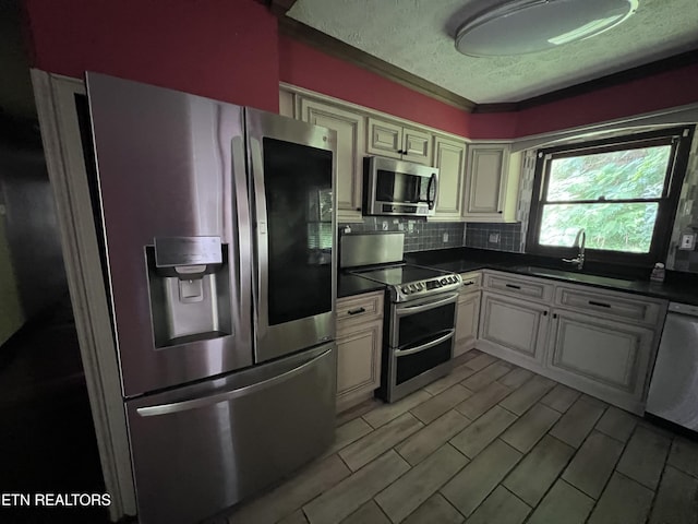 435 Simms Fork Rd, Arjay, KY 40902 - kitchen with stainless steel appliances, dark countertops, a textured ceiling, and decorative backsplash