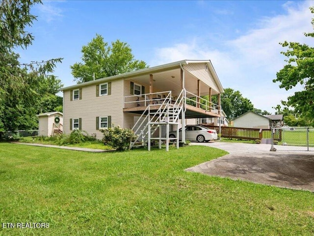 205 Ellison Rd, Lafollette, TN 37766 - back of property featuring a carport, stairway, and driveway