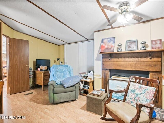 205 Ellison Rd, Lafollette, TN 37766 - living area with lofted ceiling, wood finished floors, a ceiling fan, and a fireplace