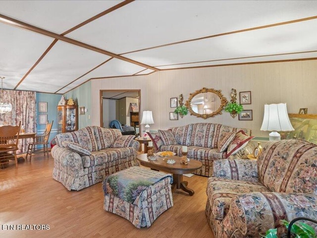 205 Ellison Rd, Lafollette, TN 37766 - living room featuring wood finished floors, a chandelier, and wood walls