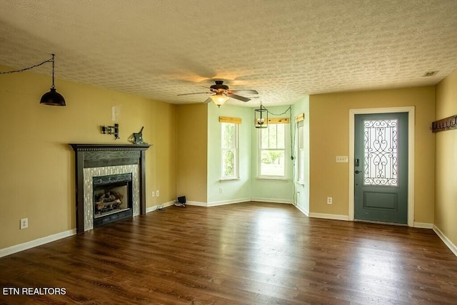 4148 New Home Rd, Smithville, TN 37166 - unfurnished living room featuring a ceiling fan, a fireplace, a textured ceiling, and dark wood-style flooring