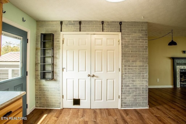 4148 New Home Rd, Smithville, TN 37166 - unfurnished bedroom with wood finished floors, a closet, a fireplace, and a textured ceiling