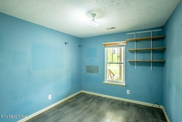 4148 New Home Rd, Smithville, TN 37166 - unfurnished room featuring dark wood-type flooring and a textured ceiling