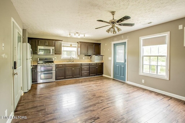4148 New Home Rd, Smithville, TN 37166 - kitchen with appliances with stainless steel finishes, a textured ceiling, dark wood-style flooring, light countertops, and dark brown cabinets