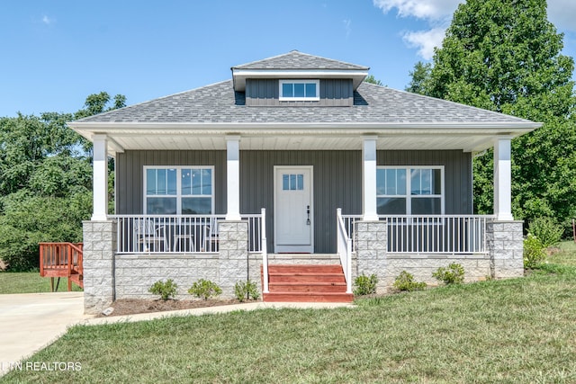 177 Hidden River Ave, Sparta, TN 38583 - view of front of house with roof with shingles, covered porch, a front lawn, stone siding, and board and batten siding