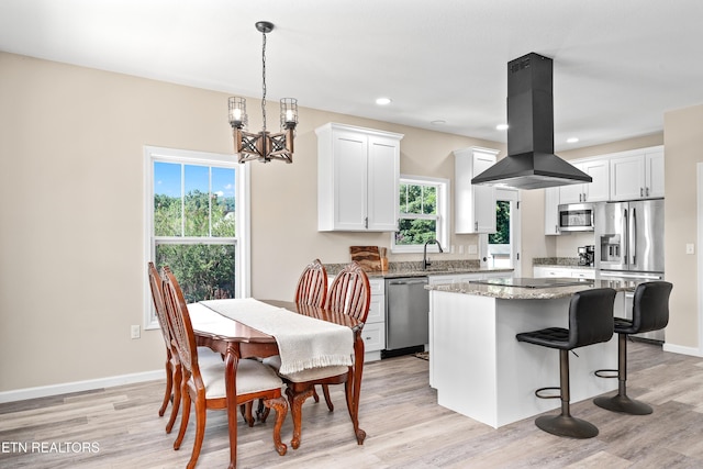 177 Hidden River Ave, Sparta, TN 38583 - kitchen with island exhaust hood, stainless steel appliances, a chandelier, healthy amount of natural light, and recessed lighting