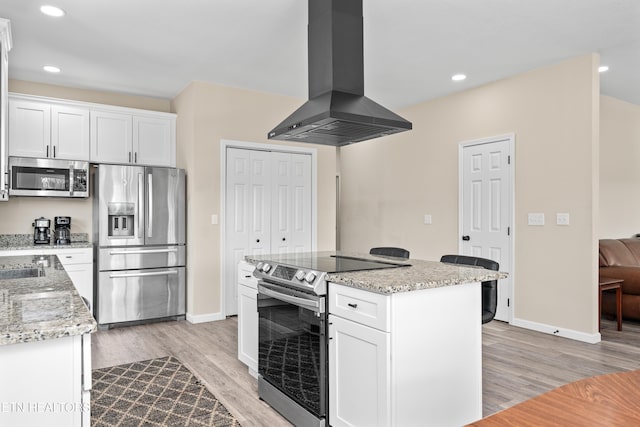 177 Hidden River Ave, Sparta, TN 38583 - kitchen with stainless steel appliances, ventilation hood, light wood-style floors, light stone countertops, and white cabinets