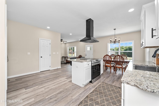 177 Hidden River Ave, Sparta, TN 38583 - kitchen with island range hood, stainless steel range with electric cooktop, white cabinetry, light wood finished floors, and a kitchen island