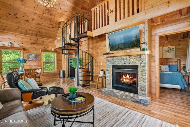 2011 Ridgecrest Loop Ln, Sevierville, TN 37876 - living area featuring wood walls, stairway, high vaulted ceiling, a fireplace, and wood finished floors