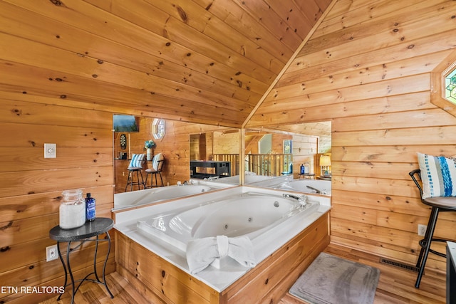 2011 Ridgecrest Loop Ln, Sevierville, TN 37876 - full bath with wooden walls, a whirlpool tub, vaulted ceiling, wood ceiling, and wood finished floors