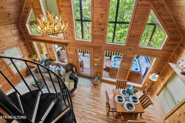 2011 Ridgecrest Loop Ln, Sevierville, TN 37876 - living room with a chandelier, wooden walls, a towering ceiling, and wood finished floors