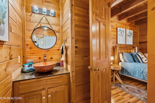 2011 Ridgecrest Loop Ln, Sevierville, TN 37876 - bathroom featuring wood walls, vanity, wood finished floors, ensuite bath, and a wood ceiling with exposed beams