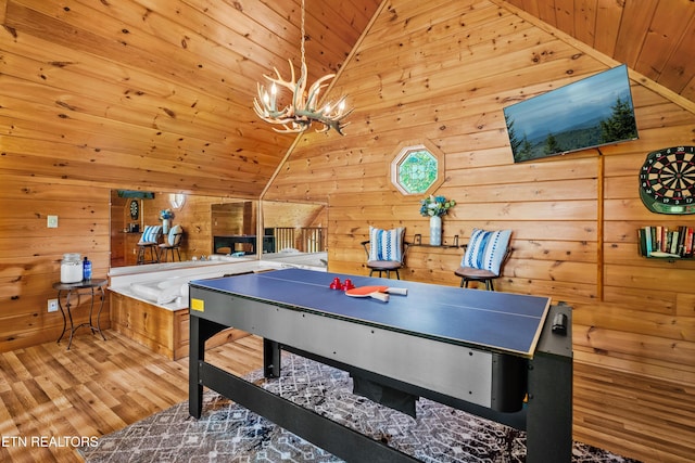 2011 Ridgecrest Loop Ln, Sevierville, TN 37876 - playroom with lofted ceiling, wooden ceiling, wood walls, wood finished floors, and a chandelier