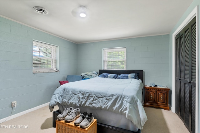 898 W Cunningham St, Alcoa, TN 37701 - carpeted bedroom with multiple windows, concrete block wall, and a closet